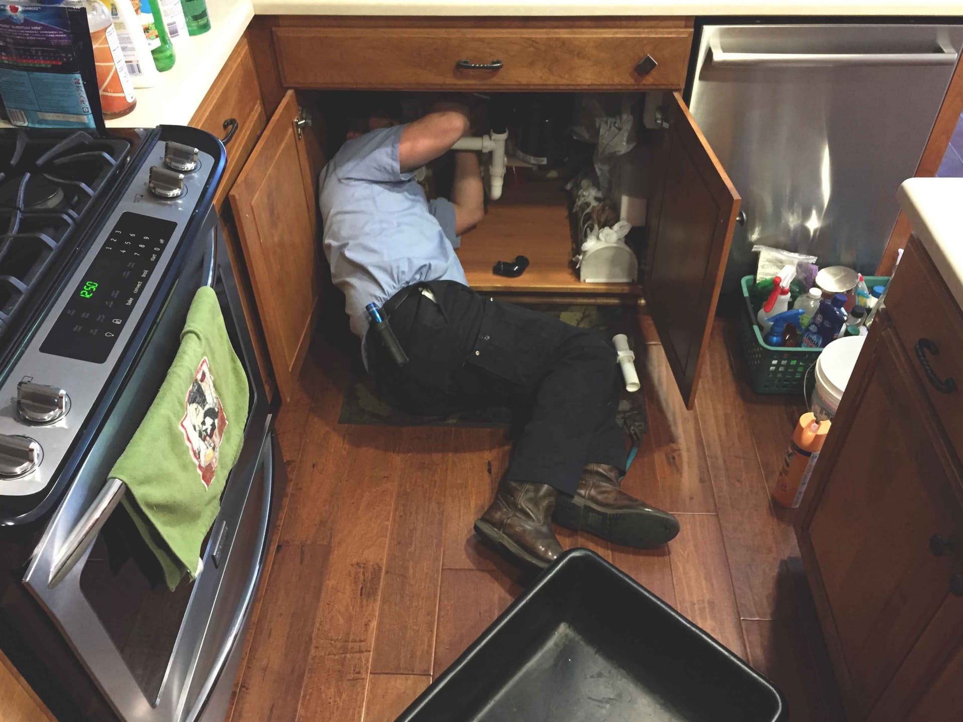 man-working-under-the-kitchen-sink-fixing,jpg