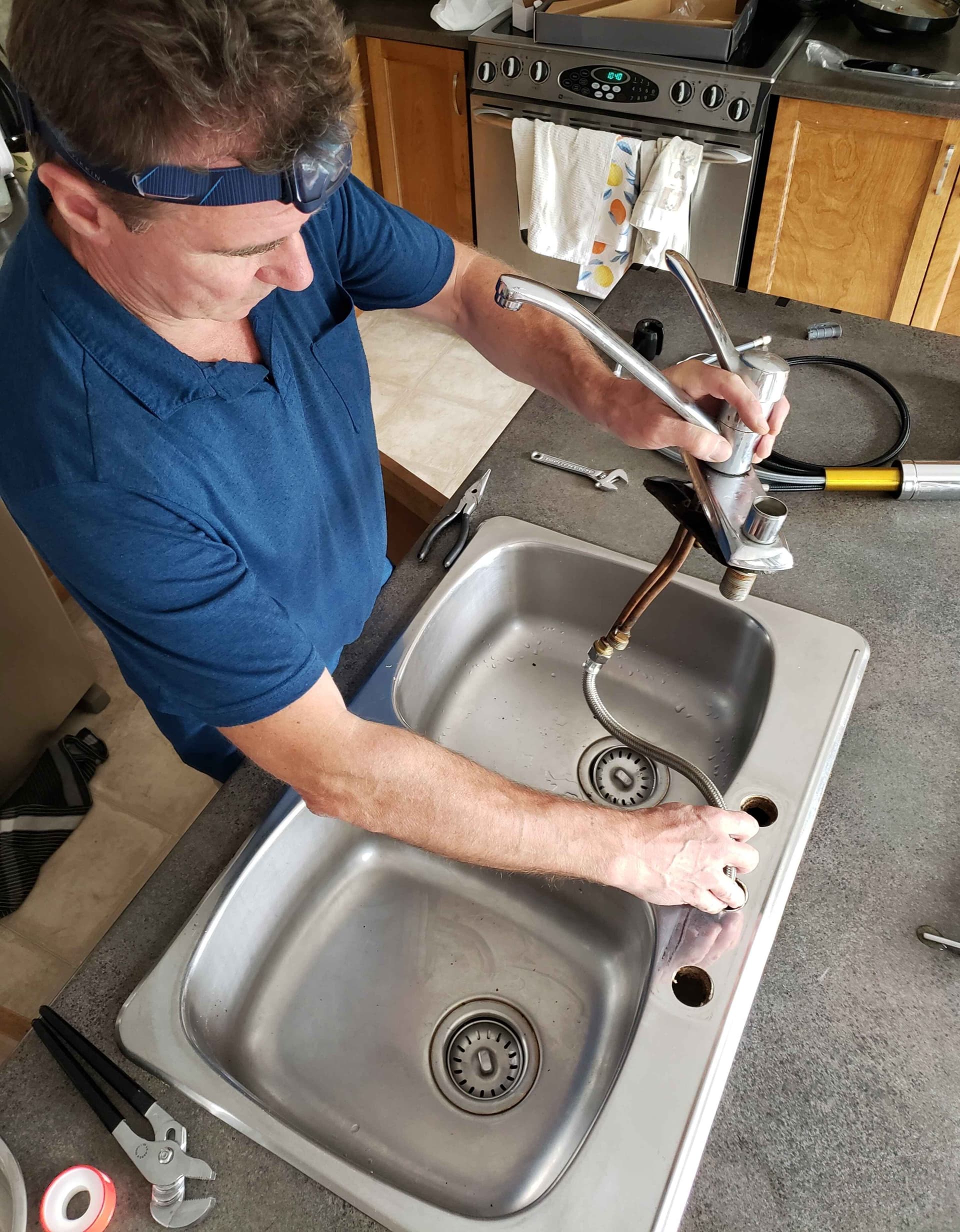 overhead-view-of-man-repairing-faucet,jpg