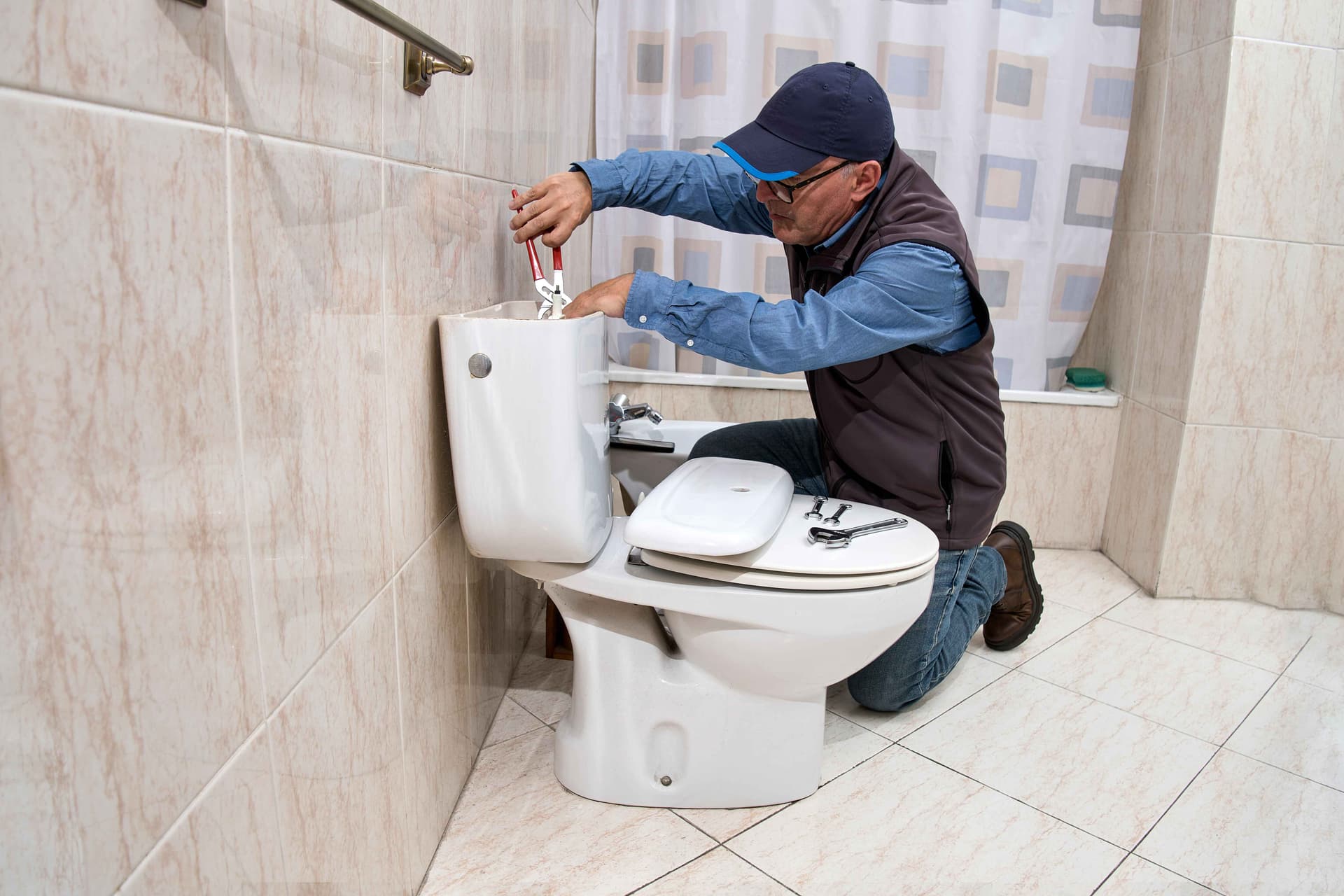 plumber-repairing-a-toilet-cistern,jpg